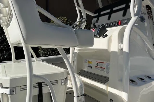 Slide: The Image of 2026 Mako 24 APEX boat interior with helm and seating area. - 6