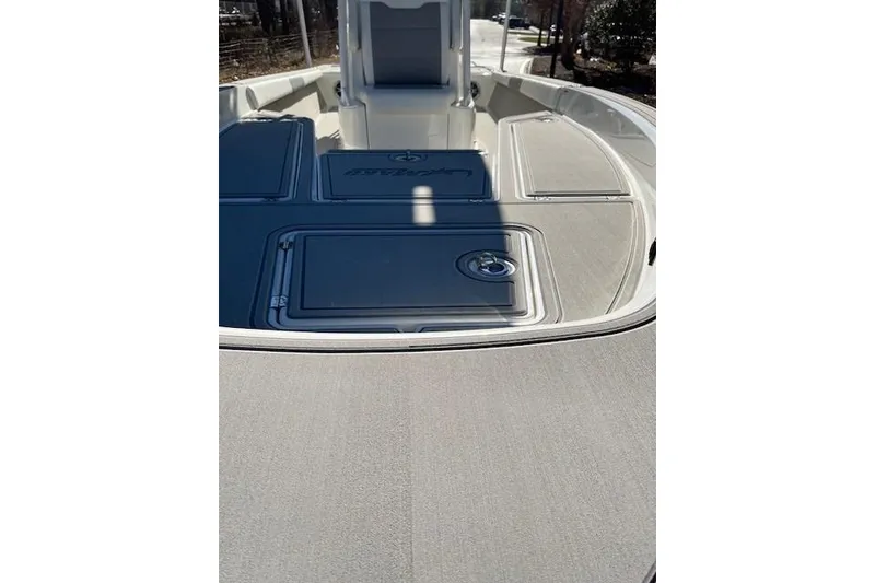 Slide: The Image of 2026 Mako 24 APEX boat deck with sleek design and storage compartments. - 8