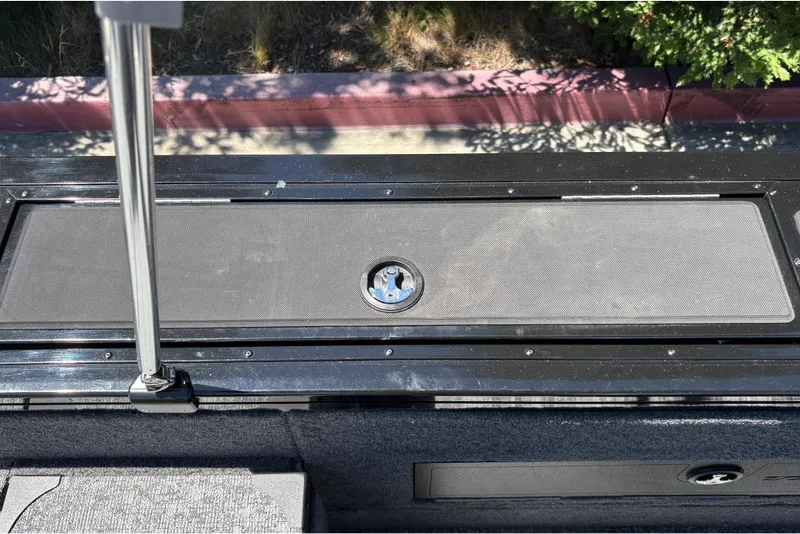 Slide: The Image of 2026 Tracker Targa V-18 Combo boat deck with storage compartment and latch. - 56