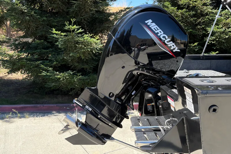 Slide: The Image of Mercury outboard motor on 2026 Tracker Targa V-18 Combo boat, parked near trees. - 12