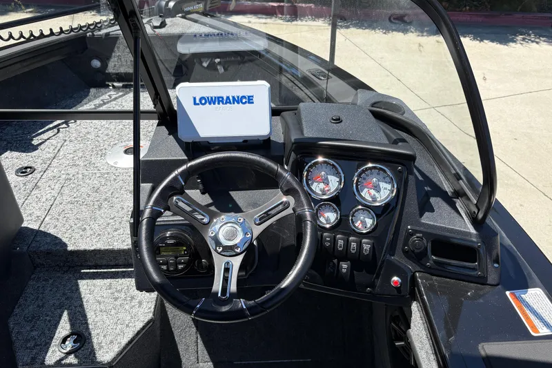 Slide: The Image of 2026 Tracker Targa V-18 Combo boat dashboard with Lowrance electronics and steering wheel. - 37