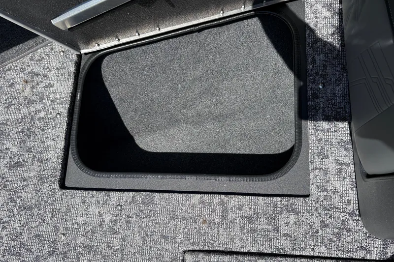 Slide: The Image of 2026 Tracker Targa V-18 Combo boat storage compartment with textured flooring. - 18