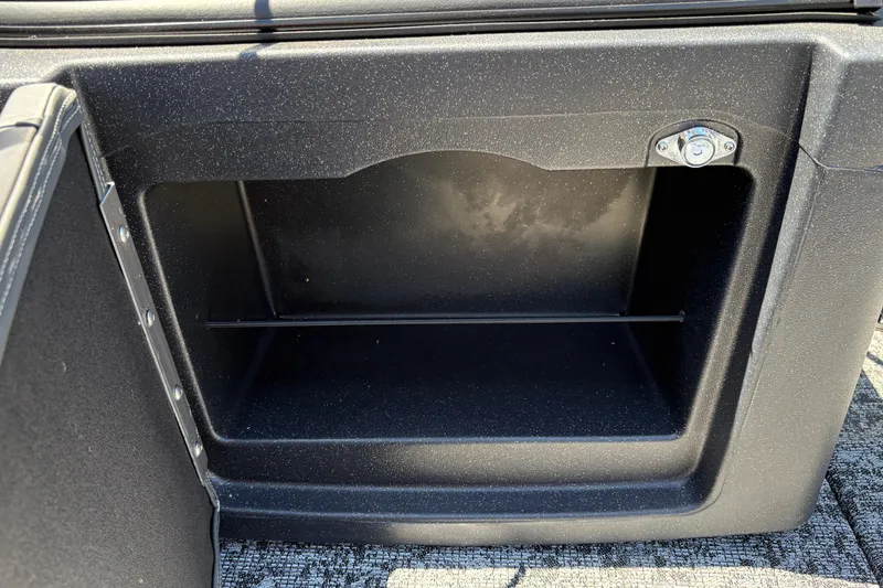 Slide: The Image of Storage compartment in a 2026 Tracker Targa V-18 Combo boat, featuring a secure lock. - 23