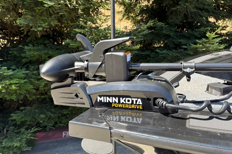 Slide: The Image of Minn Kota PowerDrive motor on 2026 Tracker Targa V-18 Combo boat, surrounded by greenery. - 40
