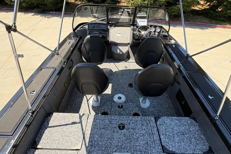 Slide: The Image of 2026 Tracker Targa V-18 Combo boat interior with seating and steering console. - 38