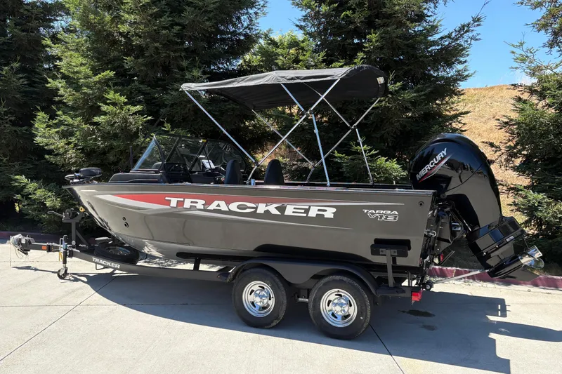 Slide: The Image of 2026 Tracker Targa V-18 Combo boat with Mercury engine, parked on a trailer. - 4