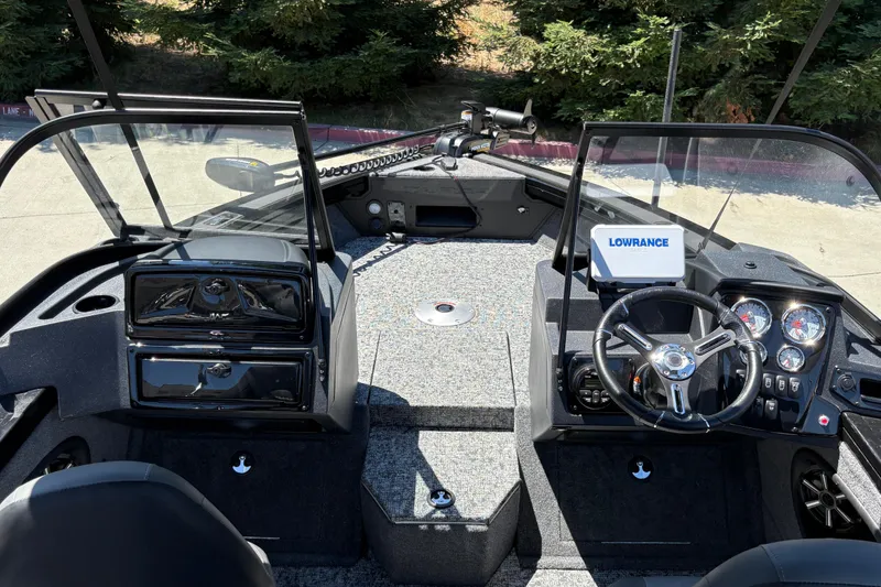 Slide: The Image of 2026 Tracker Targa V-18 Combo boat interior with steering wheel and Lowrance electronics. - 29