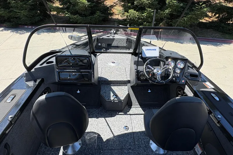 Slide: The Image of 2026 Tracker Targa V-18 Combo boat interior with steering wheel and dashboard controls. - 39