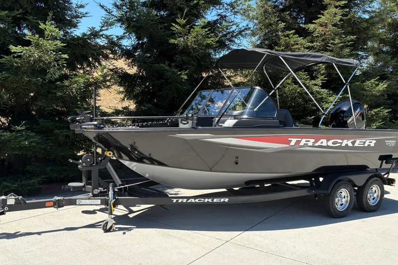Slide: The Image of 2026 Tracker Targa V-18 Combo boat on trailer, parked outdoors. - 5