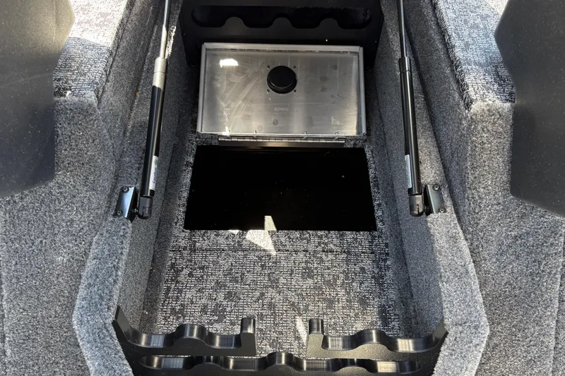 Slide: The Image of Interior storage compartment of 2026 Tracker Targa V-18 Combo boat, featuring carpeted flooring. - 26