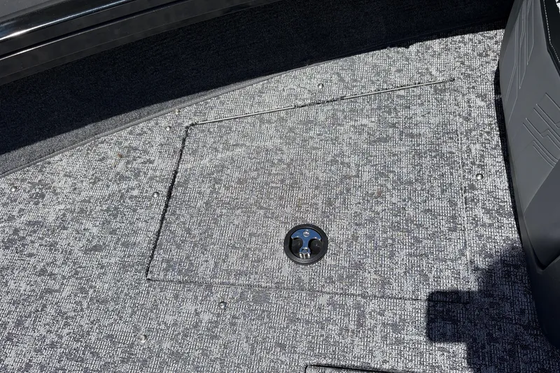 Slide: The Image of Carpeted deck of 2026 Tracker Targa V-18 Combo boat with storage hatch. - 19