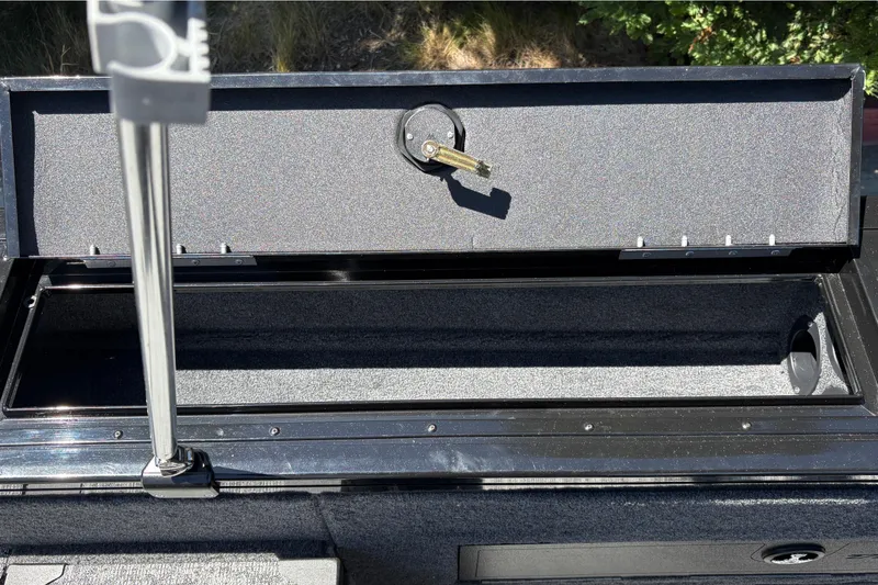 Slide: The Image of Open storage compartment on 2026 Tracker Targa V-18 Combo boat, showcasing interior space. - 53