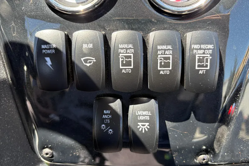 Slide: The Image of Control panel of 2026 Tracker Targa V-18 Combo boat with various switches. - 34