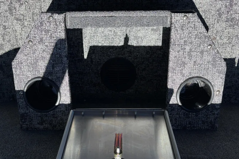 Slide: The Image of Interior of 2026 Tracker Targa V-18 Combo boat with storage compartments and cup holders. - 48