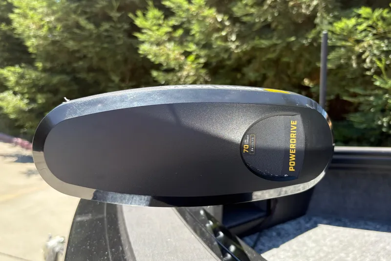 Slide: The Image of PowerDrive motor on 2026 Tracker Targa V-18 Combo boat, surrounded by greenery. - 43
