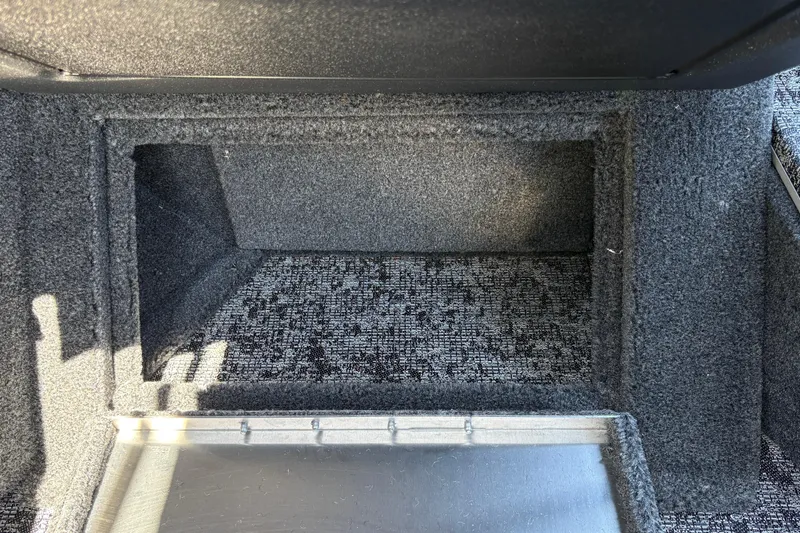 Slide: The Image of Interior storage compartment of 2026 Tracker Targa V-18 Combo boat, carpeted and spacious. - 47