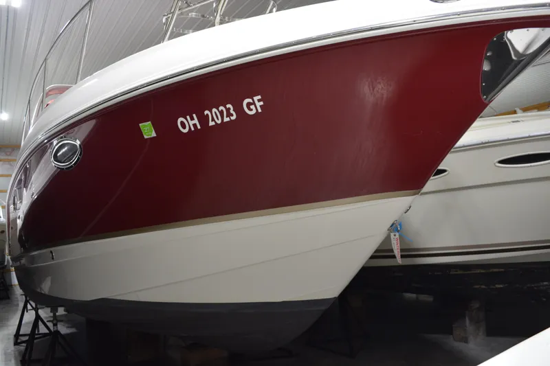 Slide: The Image of 2004 Chaparral Signature 290 boat with red hull, stored indoors. - 10