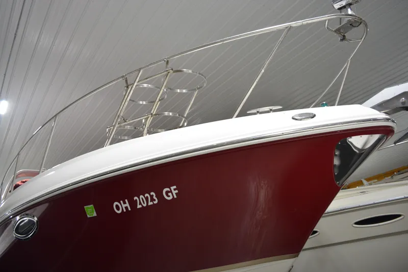 Slide: The Image of 2004 Chaparral Signature 290 boat with red hull, docked indoors. - 12