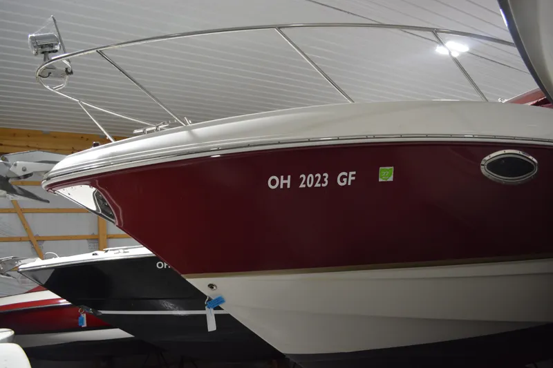 Slide: The Image of 2004 Chaparral Signature 290 boat in storage, red and white exterior, registration OH 2023 GF. - 13