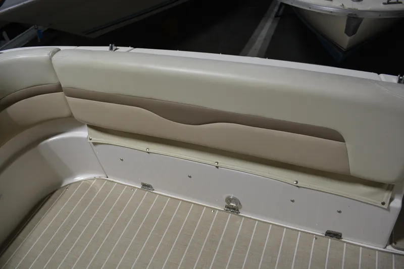 Slide: The Image of 2004 Chaparral Signature 290 boat interior with beige seating and striped flooring. - 18