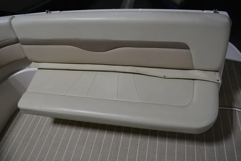 Slide: The Image of 2004 Chaparral Signature 290 boat interior seating, beige upholstery, and striped flooring. - 19