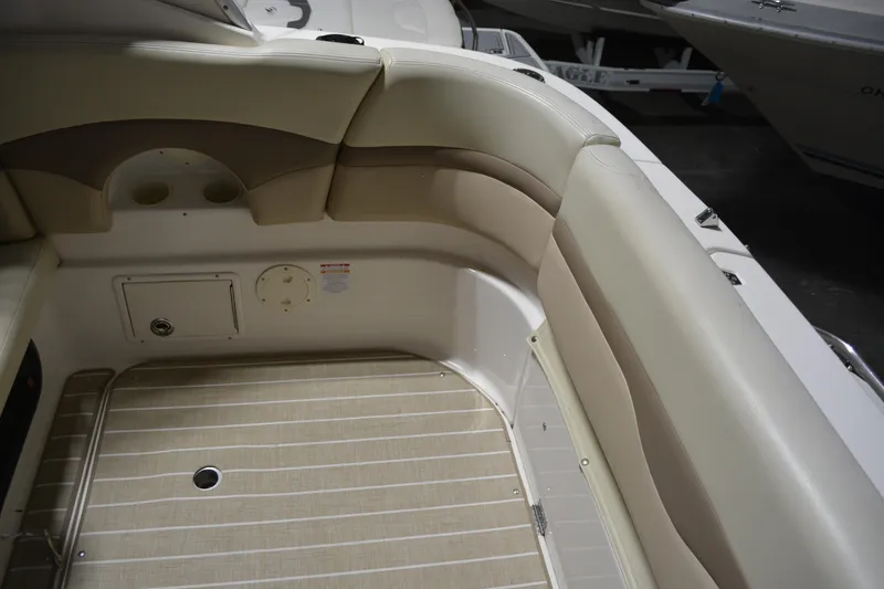 Slide: The Image of 2004 Chaparral Signature 290 boat interior with beige seating and striped flooring. - 20