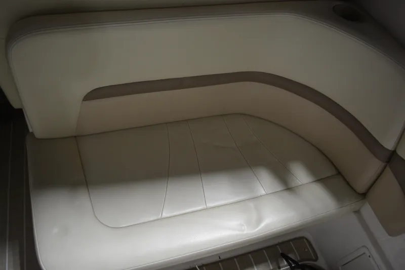 Slide: The Image of 2004 Chaparral Signature 290 boat interior seating, beige upholstery with cup holder. - 21