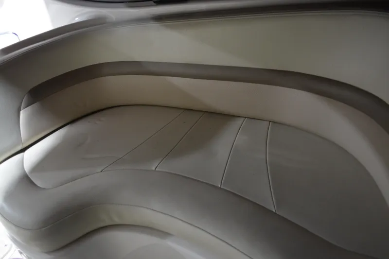 Slide: The Image of 2004 Chaparral Signature 290 boat interior seating, featuring curved, cushioned design. - 22