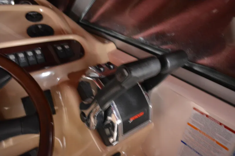 Slide: The Image of 2004 Chaparral Signature 290 boat control panel with steering wheel and throttle. - 26