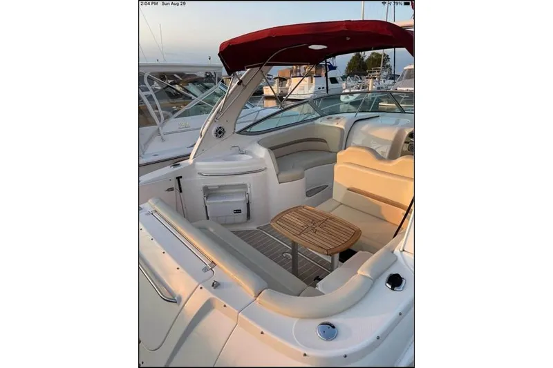 Slide: The Image of 2004 Chaparral Signature 290 boat interior with seating and wooden table. - 3