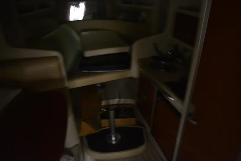 Slide: The Image of Dimly lit interior of a 2004 Chaparral Signature 290 boat cabin. - 30