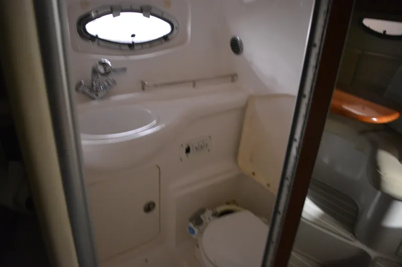 Slide: The Image of 2004 Chaparral Signature 290 boat bathroom interior with sink and toilet. - 42
