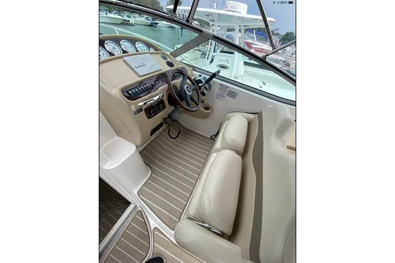 Slide: The Image of 2004 Chaparral Signature 290 boat interior with steering wheel and beige seating. - 5