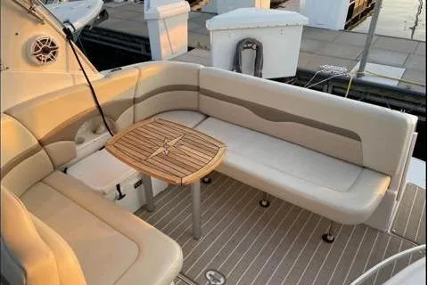 Slide: The Image of 2004 Chaparral Signature 290 boat with elegant seating and wooden table. - 6