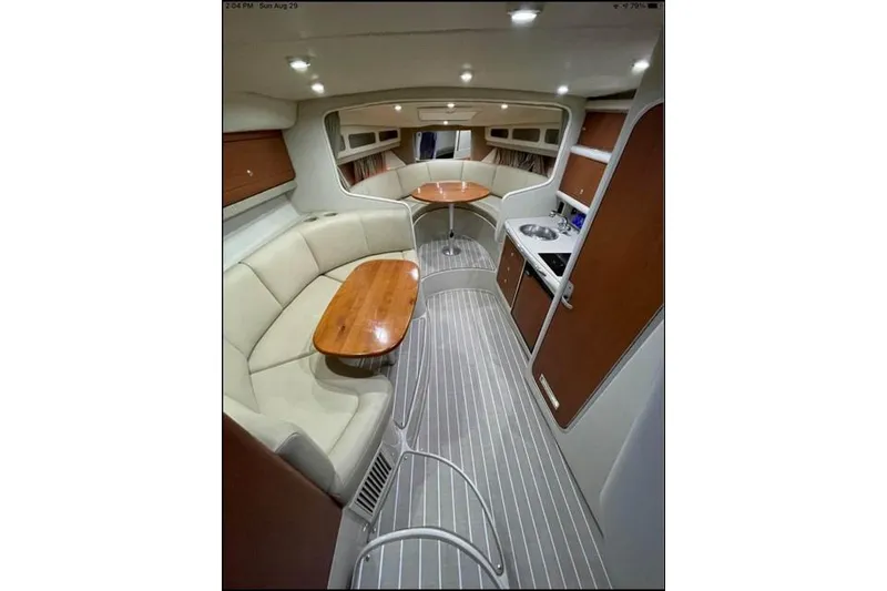 Slide: The Image of 2004 Chaparral Signature 290 interior with seating, tables, and kitchenette. - 7