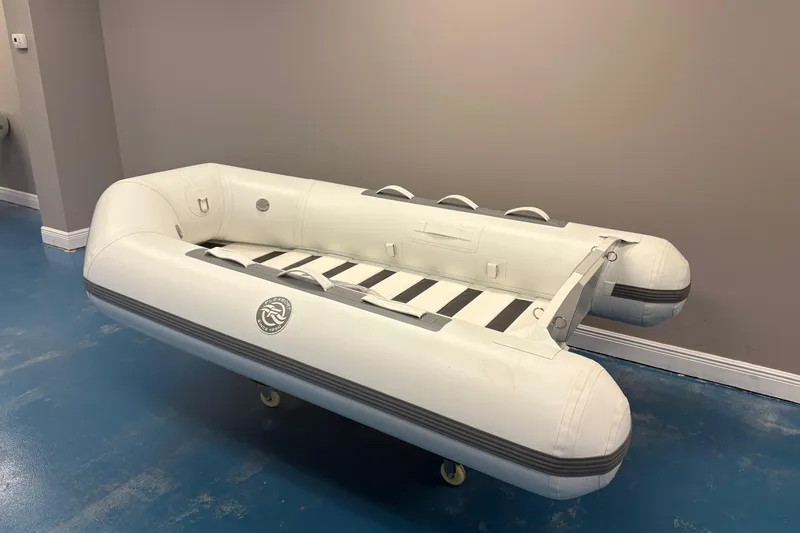 Slide: The Image of 2025 Flexboat TD-8 inflatable dinghy displayed indoors with decorative plants. - 3