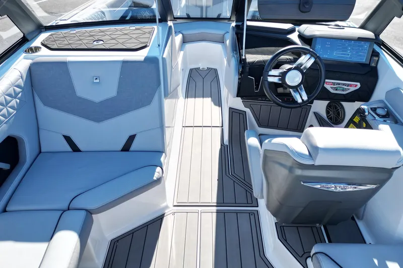 Slide: The Image of 2023 Nautique Super Air Nautique GS22 interior with modern dashboard and seating. - 10
