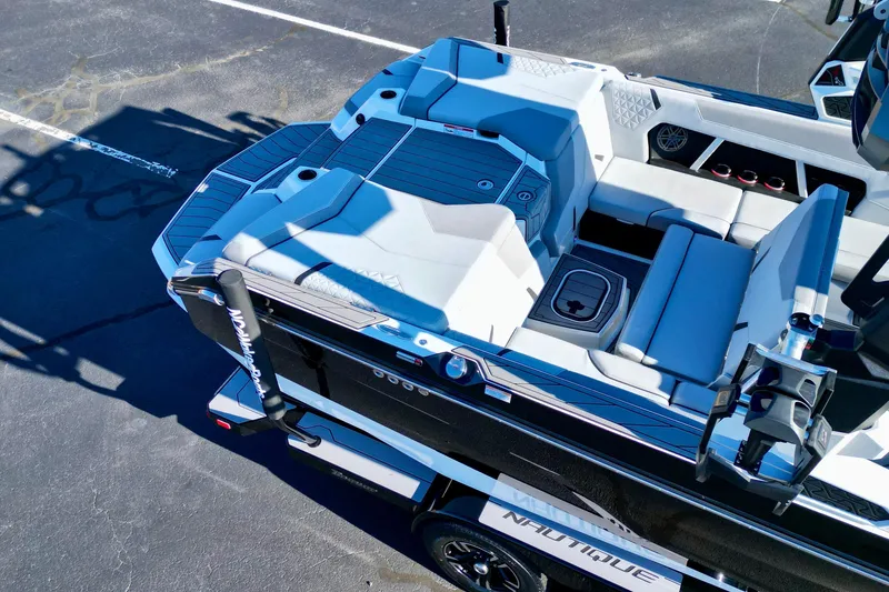 Slide: The Image of 2023 Nautique Super Air Nautique GS22 boat interior with sleek seating and modern design. - 13