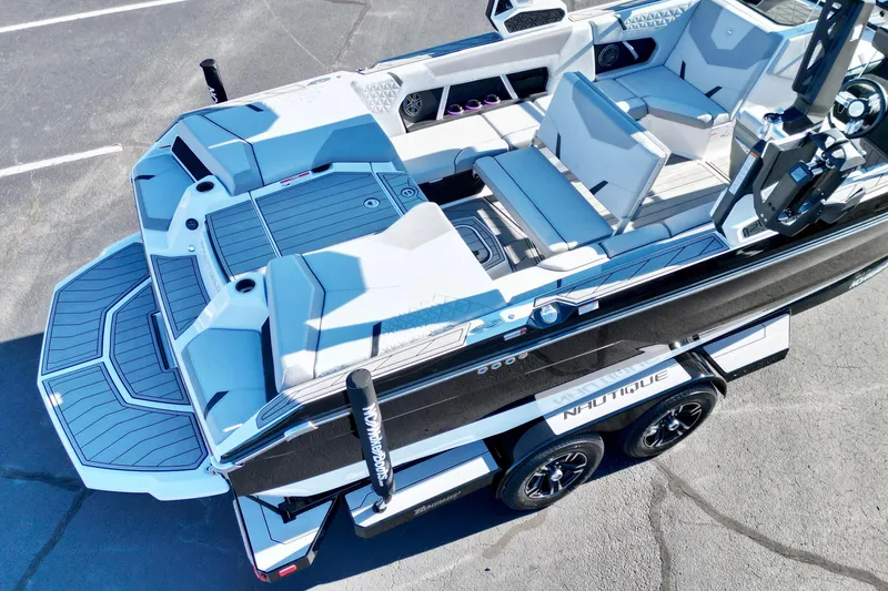 Slide: The Image of 2023 Nautique Super Air Nautique GS22 boat, aerial view, sleek design, spacious seating. - 15