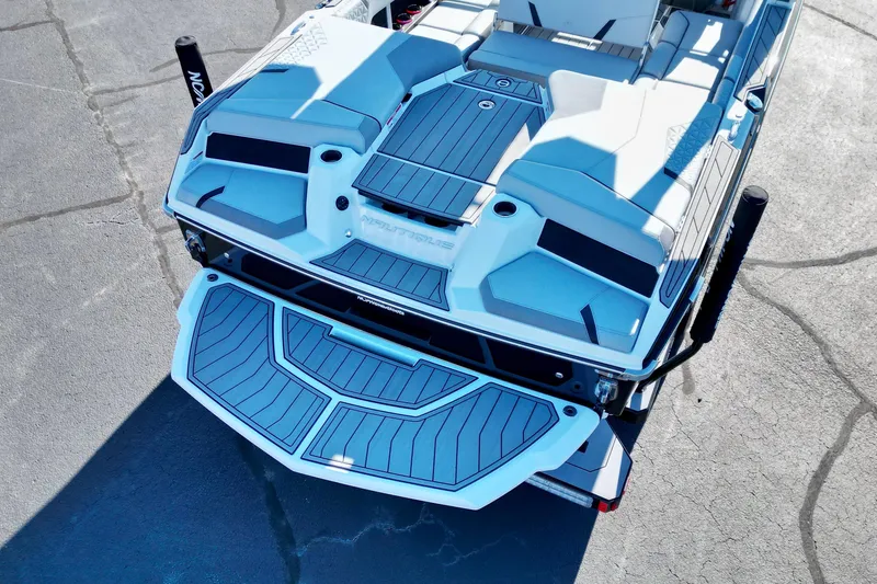 Slide: The Image of 2023 Nautique Super Air Nautique GS22 boat, rear view, showcasing deck and seating. - 16