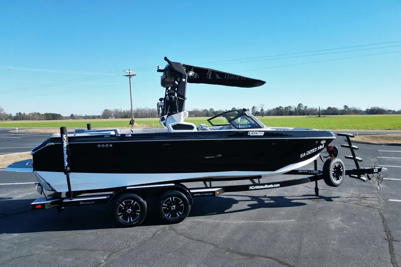 Slide: The Image of 2023 Nautique Super Air Nautique GS22 boat on trailer, black and white design. - 3