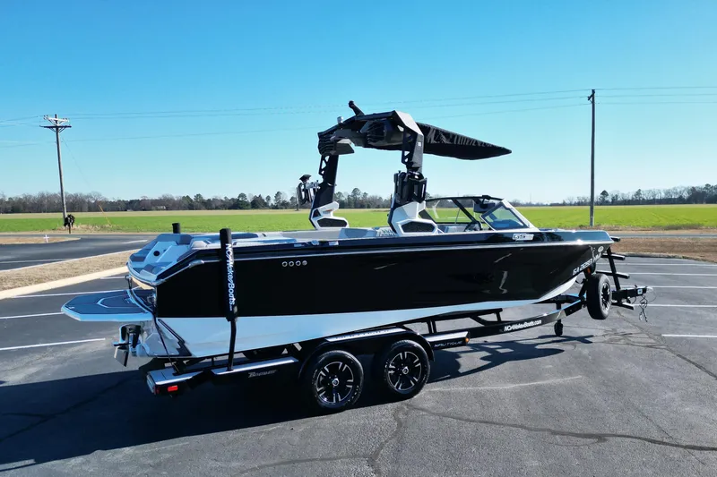 Slide: The Image of 2023 Nautique Super Air Nautique GS22 boat on trailer, parked in sunny outdoor setting. - 4