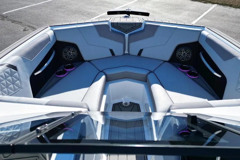 Slide: The Image of 2023 Nautique Super Air Nautique GS22 boat interior with luxurious seating and cup holders. - 9