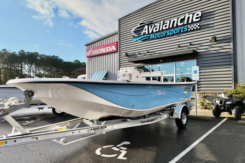 Slide: The Image of 2026 Carolina Skiff 21 LS boat on trailer at Avalanche Motorsports dealership. - 8
