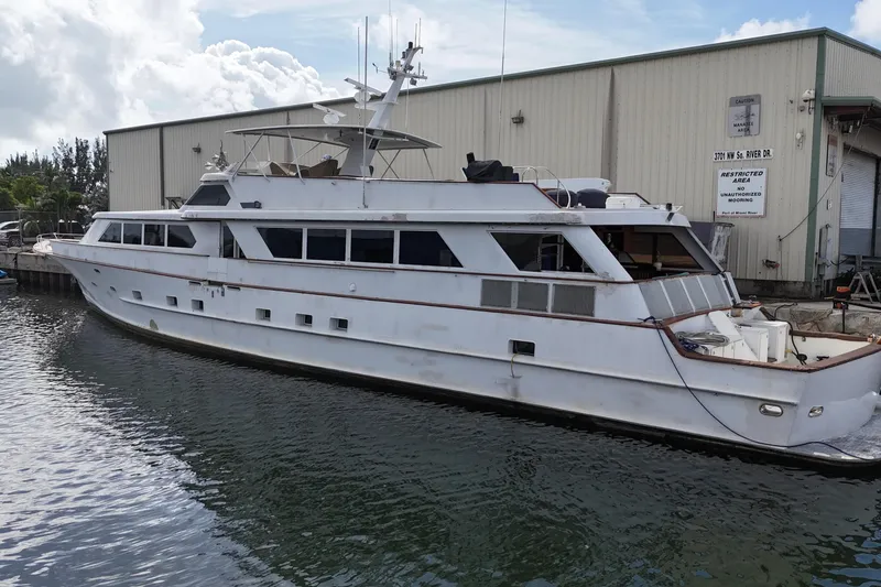 Slide: The Image of 1990 Denison Pilothouse Cockpit Motoryacht docked near industrial building. - 12
