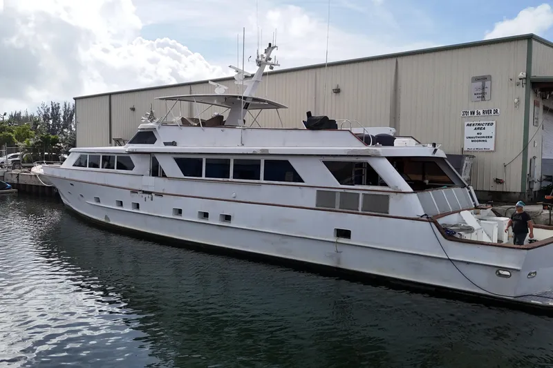 Slide: The Image of 1990 Denison Pilothouse Cockpit Motoryacht docked near a warehouse. - 15