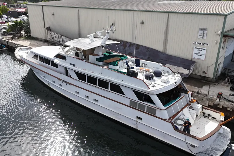 Slide: The Image of 1990 Denison Pilothouse Cockpit Motoryacht docked near a warehouse, aerial view. - 16