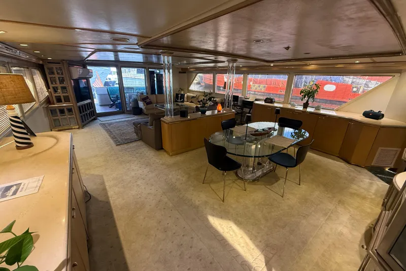 Slide: The Image of Luxurious interior of 1990 Denison Pilothouse Cockpit Motoryacht with elegant dining area and seating. - 20