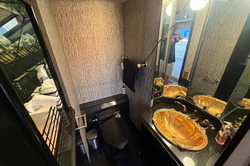 Slide: The Image of Luxurious bathroom in 1990 Denison Pilothouse Cockpit Motoryacht with gold sink and modern fixtures. - 26