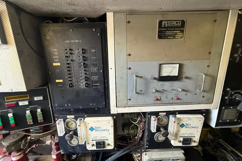 Slide: The Image of Control panel of a 1990 Denison Pilothouse Cockpit Motoryacht with voltage regulator and gauges. - 30
